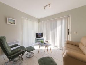 a living room with a couch and chairs and a table at Apartment Estepona by Interhome in Mispelburg +14 photos