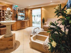 a bathroom with a sink and a bath tub at Apartment Ladis-10 by Interhome in Ladis