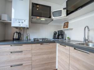 a kitchen with a sink and a counter top at Holiday Home Les Villas de l'Aygual-4 by Interhome in Saint-Cyprien-Plage