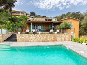 a swimming pool in front of a house at Holiday Home Gloria by Interhome in Calonge
