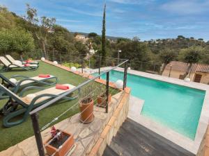 a swimming pool with a slide next to a house at Holiday Home Gloria by Interhome in Calonge