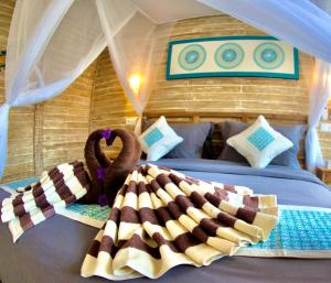 a bedroom with two beds in a tent at GiliZen Resort - Private Pool Villas in Gili Air