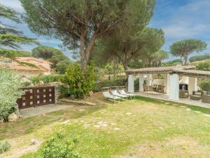 a backyard with chairs and a pergola at Holiday Home Omer by Interhome in San Teodoro