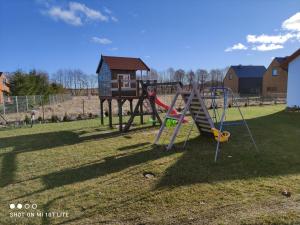 a park with a playground with a slide at Małe Kaszuby in Słajszewo