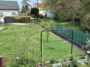 a basketball hoop in a yard with a fence at Holiday Home Leopoldau by Interhome in Vienna