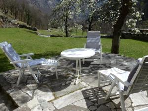eine Gruppe Stühle und ein Tisch auf einer Terrasse in der Unterkunft Holiday Home Casa Signorile by Interhome in Peccia