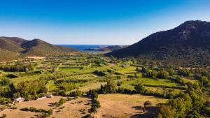 an aerial view of a valley with mountains and the ocean at Beni Benìus in Teulada