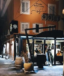 un restaurant avec un parasol dans une rue de la ville dans l'établissement Bed and Brekfast Donatella, à Piran