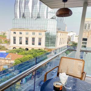 a table and chairs with a view of a city at 3T Hotel Hanoi in Hanoi