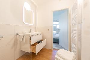 a bathroom with a sink and a mirror at Altstadt Ferienwohnungen in Wernigerode +36 photos
