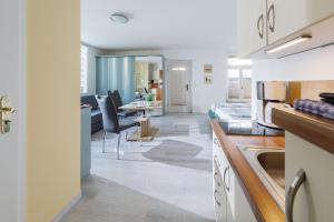 a kitchen with a dining room and a living room at Altstadt Ferienwohnungen in Wernigerode