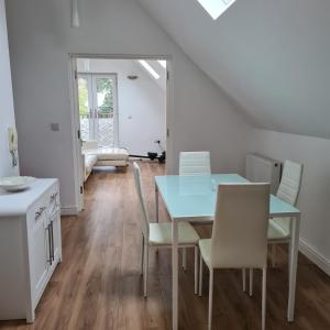 a dining room with a table and chairs at 2-Bed Loft Apartment for 5ppl with private parking in Beckenham