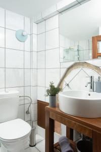 a bathroom with a sink and a toilet at Rodi House in Monemvasia