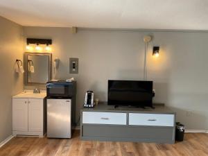 a living room with a tv on top of a dresser at Ways Motel in Hampton