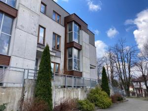 a building with trees in front of it at Apartament Miodowa 9 in Zwierzyniec +10 photos