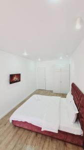 ЖК МАДИНА ЕВРА ДВУШКА في كوكشيتو: غرفة بيضاء مع سرير وأريكة