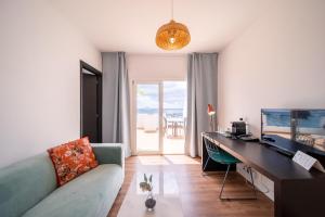 a living room with a couch and a desk at Apartamentos Islamar Arrecife in Arrecife