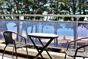 a table and chairs sitting in front of a window at TY TREZ Magnifique vue mer à Bénodet 10 Avenue de la Plage Résidence "Les Glénan" in Bénodet