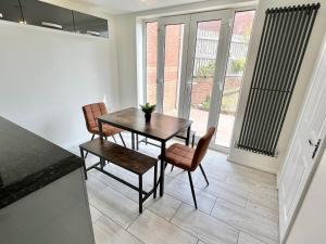 a dining room with a table and two chairs at Spacious 3-Bedroom house with 5 beds and sofa-bed in Manchester