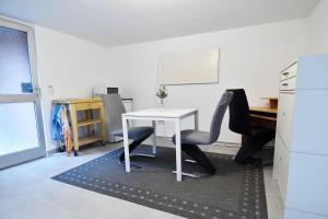 an office with a white desk and two chairs at Souterrain apartment in Wesseling in Wesseling
