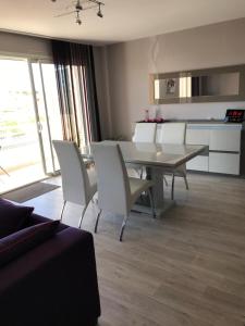 a living room with a dining room table and chairs at APPARTEMENT Résidence GARDENIAS SAINT JEAN DE MONTS in Saint-Jean-de-Monts