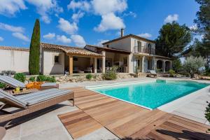 a home with a swimming pool and a house at Le Mas de Suzette in Mallemort