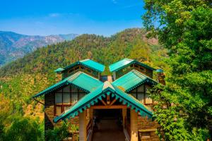 a log cabin with a view of a mountain at Zostel Homes Ramgarh, Nainital in Rāmgarh