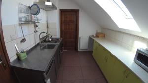a small kitchen with a sink and a stove at Pensjonat Pod Tetrapodem in Zagnańsk