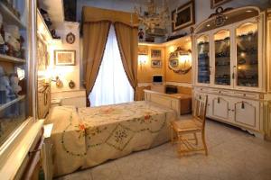 a bedroom with a bed and a dresser and a window at B&B Il Caravaggio in Catania