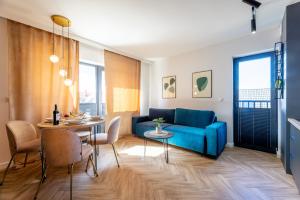 a living room with a blue couch and a table at Inny Klimat in Rowy