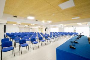 a large room with blue tables and chairs at Hotel La Principessa in Campora San Giovanni