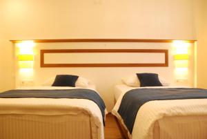 A bed or beds in a room at Necdet Kaptan Bozcaada