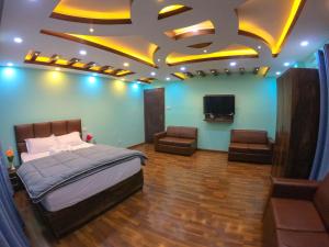 a bedroom with a bed and a flat screen tv at Greenery View Point Resort in Kathmandu