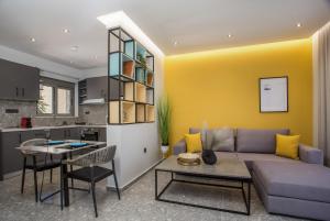 a living room with a couch and a table at GM Apartments-Rhodes Luxury Living in Kalithies