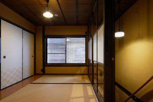 an empty hallway with a window in a room at YADORU KYOTO HANARE Kanade No Yado in Kyoto