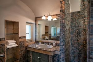 a bathroom with a sink and a mirror at La Porta del Mare in Villanova di Ostuni +44 photos