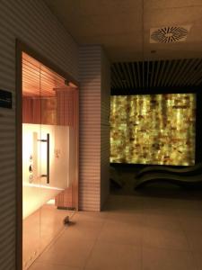 a hallway with a glass door and a window at NCM Apartments Seaside Park in Kołobrzeg +8 photos
