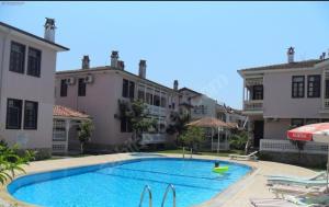 a large swimming pool in front of some buildings at PEACEFUL HOUSE in Fethiye
