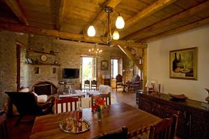 a living room with a wooden table and a fireplace at The House of Prince in Nea Stira