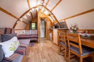 a kitchen and living room in a tiny house at Humble Bee Farm Glamping in Folkton