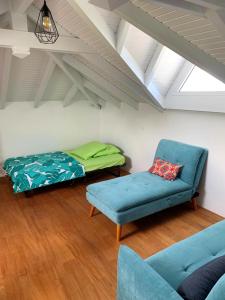 a living room with a couch and a bed at Villa de 4 chambres avec vue sur la mer piscine privee et jacuzzi a Le Marin a 3 km de la plage in Le Marin