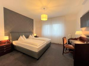Postel nebo postele na pokoji v ubytování Hotel Garni Geisler