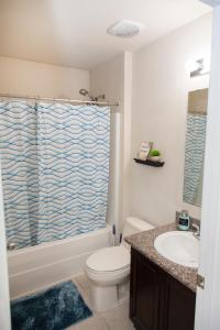 a bathroom with a toilet and a sink at Beachy Bliss the perfect stay in Navarre
