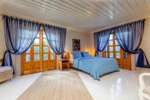 a bedroom with a large bed and a large window at Jade Residence in Oludeniz
