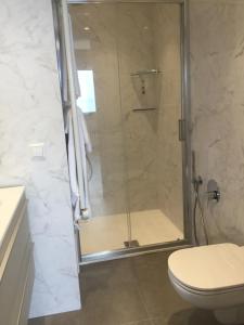 a shower with a glass door in a bathroom at CASA COSTA AL SOLE APARTMENT 2 in Lazise