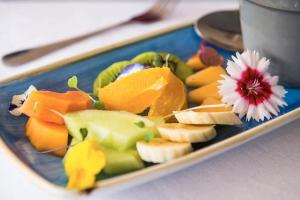 a plate of fruit and vegetables on a table at Avondale Boutique Hotel in Durban