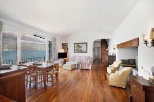 a large living room with a table and chairs at Villa Cicci e Sandro in Bellano