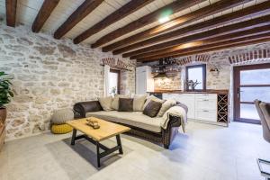 a living room with a couch and a table at Roman style stone Villa Lux Solis in Nin