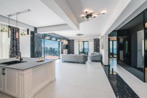 a kitchen with a sink and a living room at Barjaktar - Luxury Suites & SPA in Ulcinj