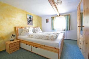 a bedroom with a large bed and a window at Almliesl GAST-387 in Bad Gastein